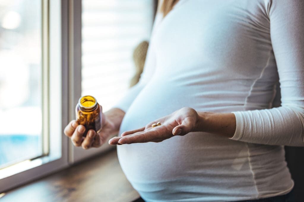 Pregnant woman taking pre-natal vitamins