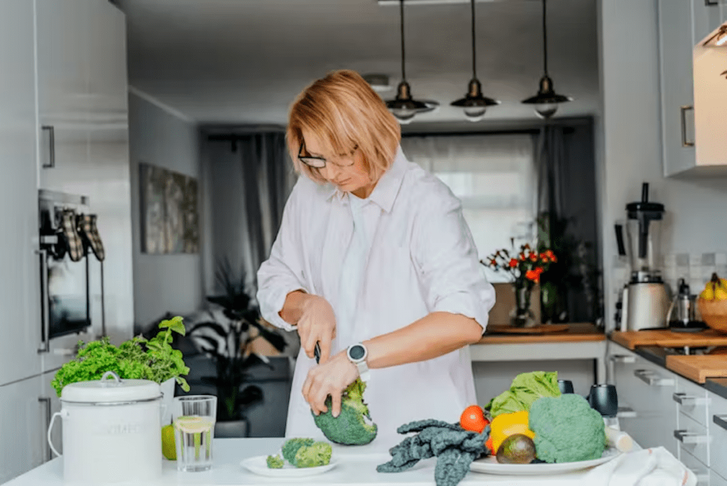 Woman preparing vegetables as part of a healthy diet for bone health