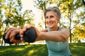 An older woman does squats to build better bones.