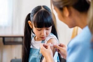 little girl getting the cold and flu vaccine